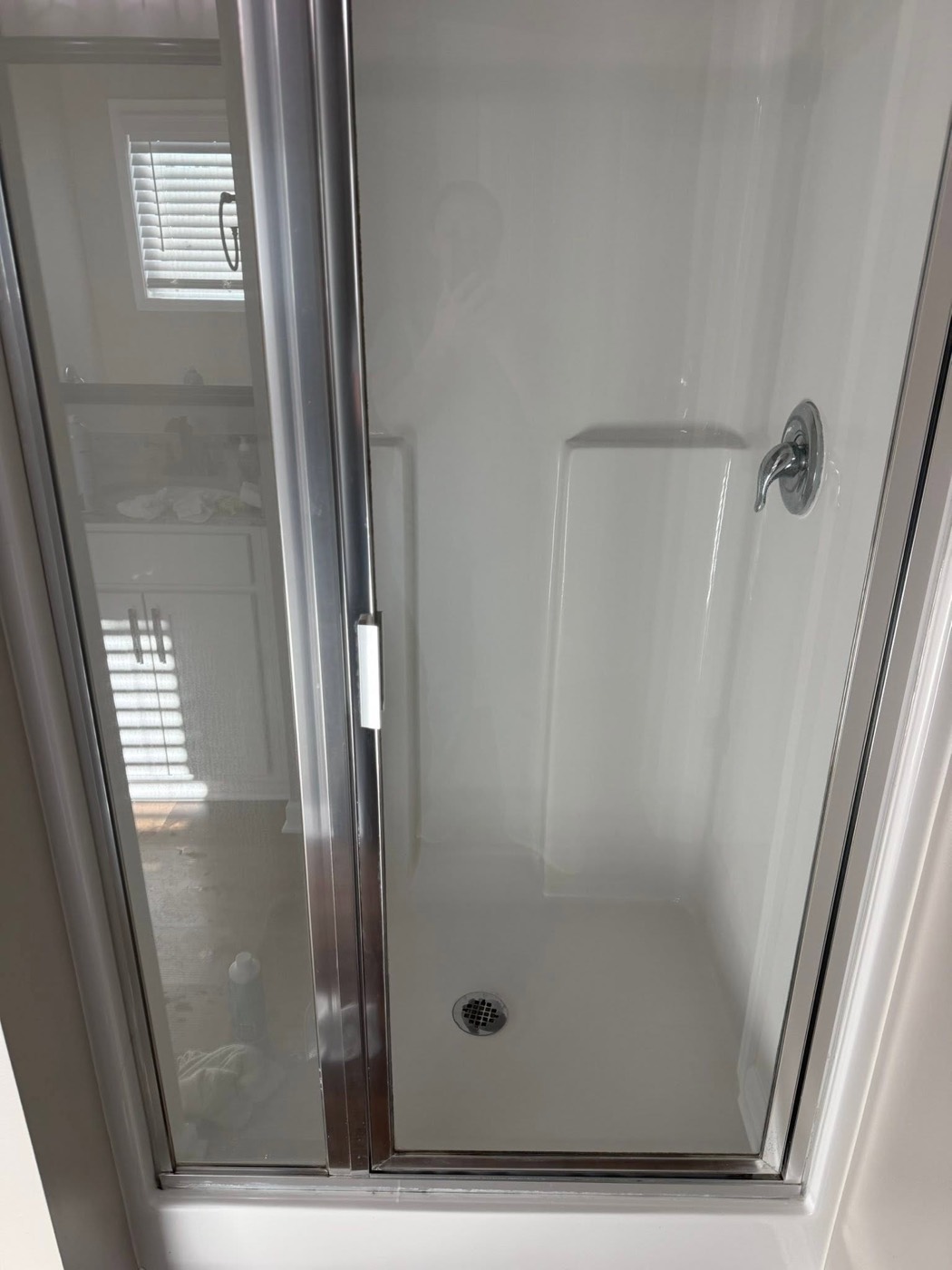 The same shower after cleaning, glass and basin clear